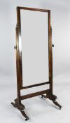 A Regency mahogany cheval mirror, with chequer banded inlaid border, with moulded supports,