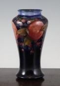 A Moorcroft Pomegranate baluster vase, c.1928, with a blue graduated ground, inscribed W. Moorcroft