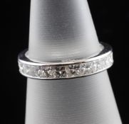 A white gold and diamond full eternity ring, set with twenty four princess cut stones with a total