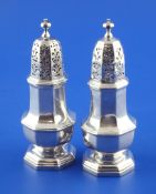 A pair of George I cast Brittania standard silver pepperettes, of octagonal form, with turned
