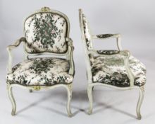A set of four Louis XV style grey painted and parcel gilt fauteuils, with floral upholstered seat,