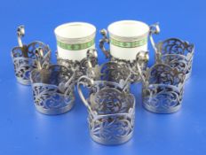 A set of six George V pierced silver coffee can holders, with flying scroll handles, Cooper