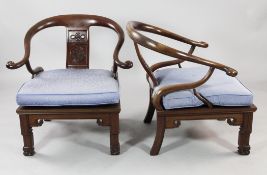A pair of 20th century Chinese rosewood horseshoe armchairs, the shaped splat with pierced endless