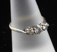 An 18ct gold and platinum three stone diamond ring, size O.