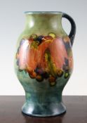 A Moorcroft flambe Leaf and Berry jug, c.1948, of baluster form, with partial flambe glaze to the