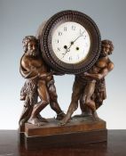 A 19th century Continental carved walnut mantel clock, the drum case supported by a pair of figures