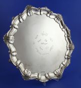 A George V silver salver, of shaped circular form, with shell and scroll border and engraved with