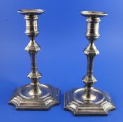 A pair of late Victorian early 18th century style silver candlesticks, with panelled knopped stems,