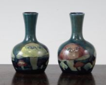 A pair of miniature Moorcroft `Claremont` bottle vases, c. 1920, with blue-green graduated grounds,