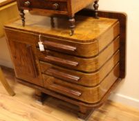 An Art Deco walnut sideboard, fitted four drawers and a single cupboard door, with rounded ends, on