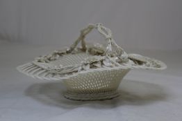 A Belleek `Henshall`s Twig` oval basket, Second Period, c.1900, the handle shaped like intertwining