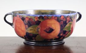 A Moorcroft Pomegranate twin handled bowl, c.1920, the interior decorated with just a band of