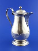 An Edwardian silver hot water pot, of plain baluster form, with loop handle lacking rattan overlay,