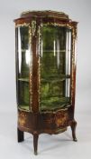 A Louis XV style brass mounted and rosewood marquetry vitrine, with single serpentine glazed door,