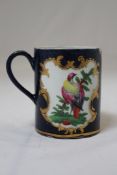 A Worcester blue ground scale straight sided mug, c.1770, decorated with painted exotic birds and