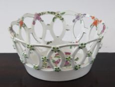 A Worcester polychrome pierced basket, c.1770, the reticulated sides interwoven with shaped