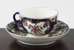 A Worcester blue scale ground coffee cup and saucer, c.1770 decorated with painted floral sprays