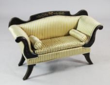 A 19th century ebonised and parcel gilt miniature scroll end settee, painted with bell flowers and