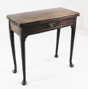 An 18th century mahogany folding tea table, with hinged top and single frieze drawer, on pole legs