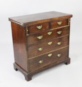 An 18th century mahogany bachelor`s chest, with folding top over two short and three long