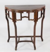 A Chinese rosewood demi lune hall table, with traditional pierced frieze, shaped legs and