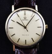 A gentleman`s gold Omega manual wind wrist watch, with baton numerals, on associated leather strap.