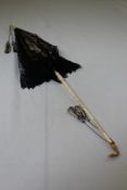 A Victorian carved ivory parasol, with textured gold duck head finial and tulle fabric, 28in.