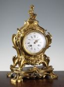 A 19th century French ormolu mantel clock, of Louis XV style, with rococo scroll case and