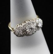 An 18ct gold and diamond triple cluster ring, size M.