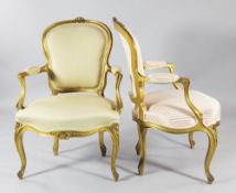 A pair of carved giltwood fauteuils, with open arms, serpentine seats and scrolling legs, one in