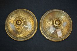 A pair of 20th century cut glass and pierced brass circular ceiling lights, with domed shades,