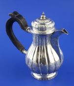 An 18th century Russian 84 zolotnik silver coffee jug, of fluted pear form, with engraved foliate