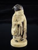A Japanese ivory and polychrome figure of Jurojin, in standing pose, holding his beard in his