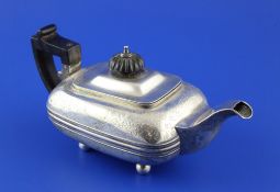 A George IV silver bachelor`s teapot, of squat rounded rectangular form, with engraved foliate