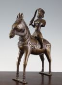 An Indian bronze group of a horse and rider, 19th century, the rider holding a shield and sword,