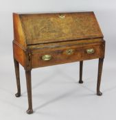 An 18th century walnut bureau, with fall front and single drawer on tapering pole legs and pad feet,