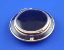 A 9ct gold mounted tortoiseshell compact, of circular form, 2in.