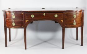 An early 19th century mahogany and boxwood inlaid breakfront sideboard, with central frieze drawer
