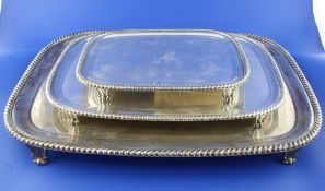 A graduated set of three 19th century silver plated salvers, of rounded rectangular form, with