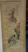 A Chinese scroll painting, early 20th century, depicting a man and woman on a hand cart, in a