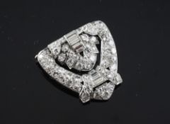 A platinum and diamond half clip brooch, of V-shape, set with graduated round and baguette cut