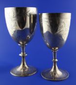 Two Victorian silver trophy cups, both with foliate engraving and turned knopped stems, on