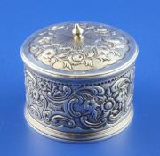 A George II embossed silver circular box and cover by Paul Crespin, with engraved armorial and
