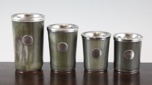 A graduated set of four Austrian horn and silver plated beakers, each with applied oval vacant