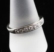 An 18ct white gold and diamond half eternity ring, set with nine round cut stones with a total