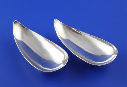 A stylish pair of 1960`s silver nut dishes, designed by Anthony Hawksley, of planished curved