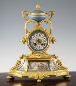 A 19th century French ormolu and Sevres style porcelain mantel clock, with urn finial and jewelled