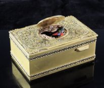 A 20th century gilt brass singing bird music box, the oval lid opening to reveal an automated