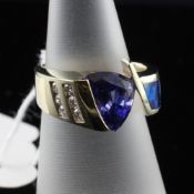 A stylish 14ct gold, black opal, tanzanite and diamond set dress ring, size K.