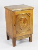 An early 20th century European oak collector`s cabinet, the single door with raised octagonal